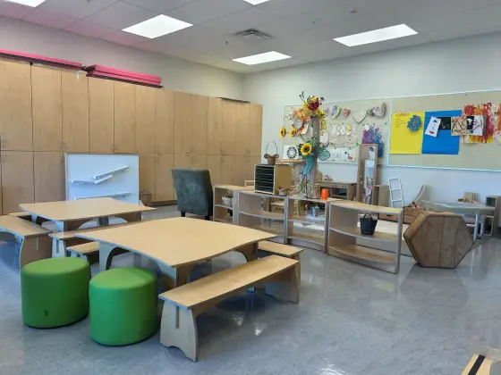Tables, benches and stools in the Butterfly Room, set up for after-school homework and activities